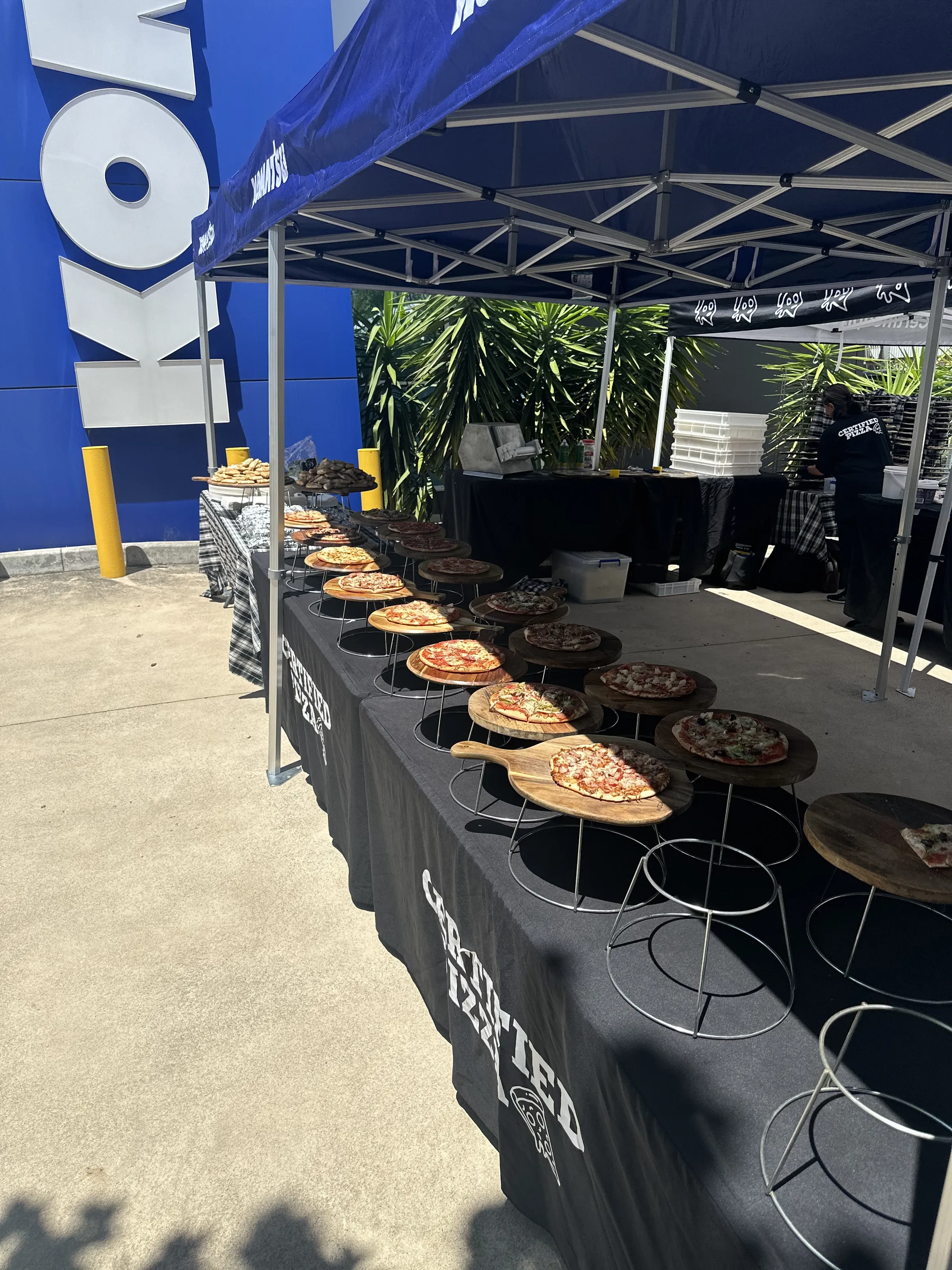 Fresh pizzas on wooden boards at Certified Pizza Catering for Komatsu in Fairfield NSW
