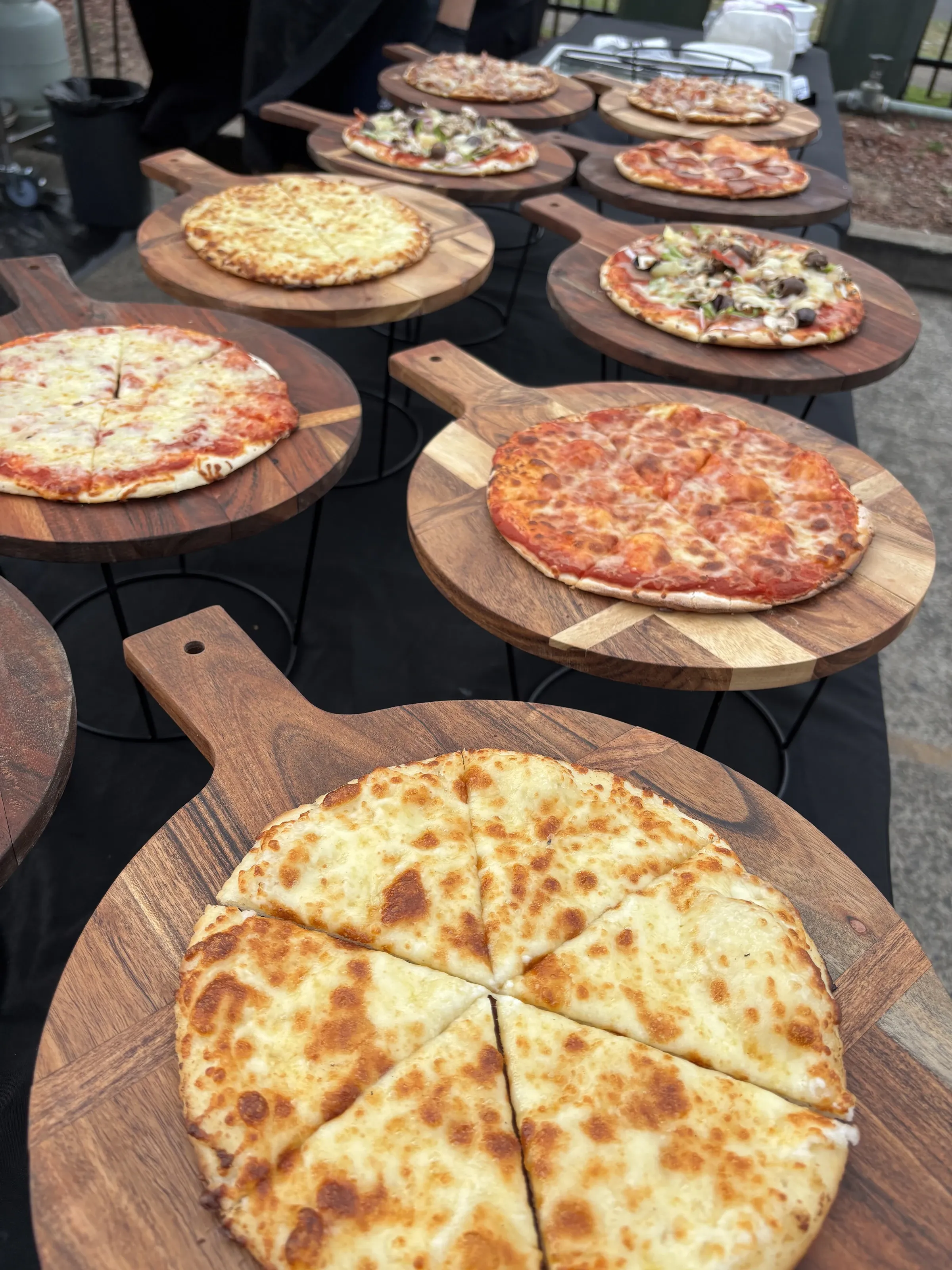Fresh pizzas on wooden boards at a Certified Pizza Catering corporate event in Narellan NSW