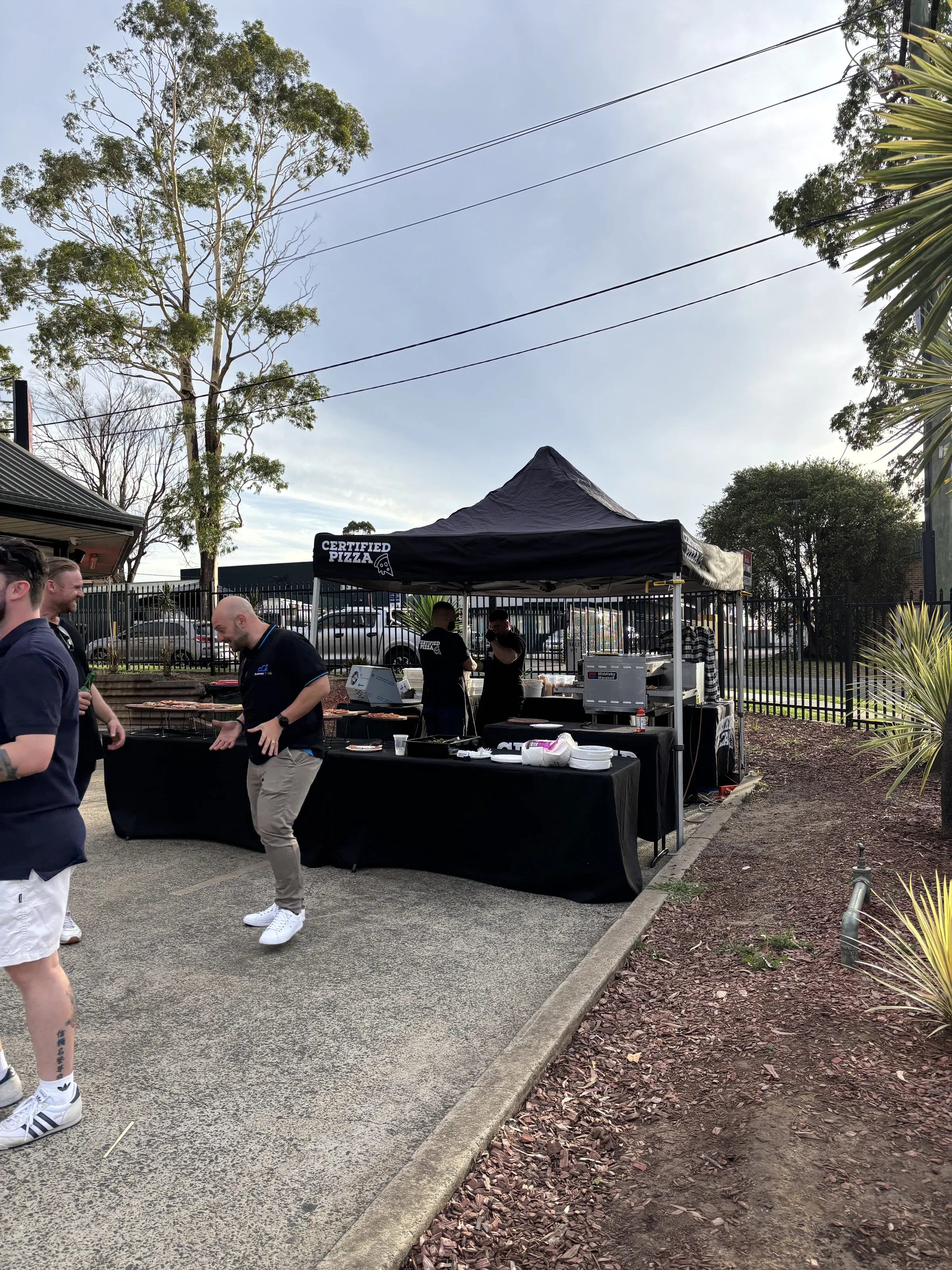 Certified Pizza branded marquee and service tables set up for Oztech catering in Narellan