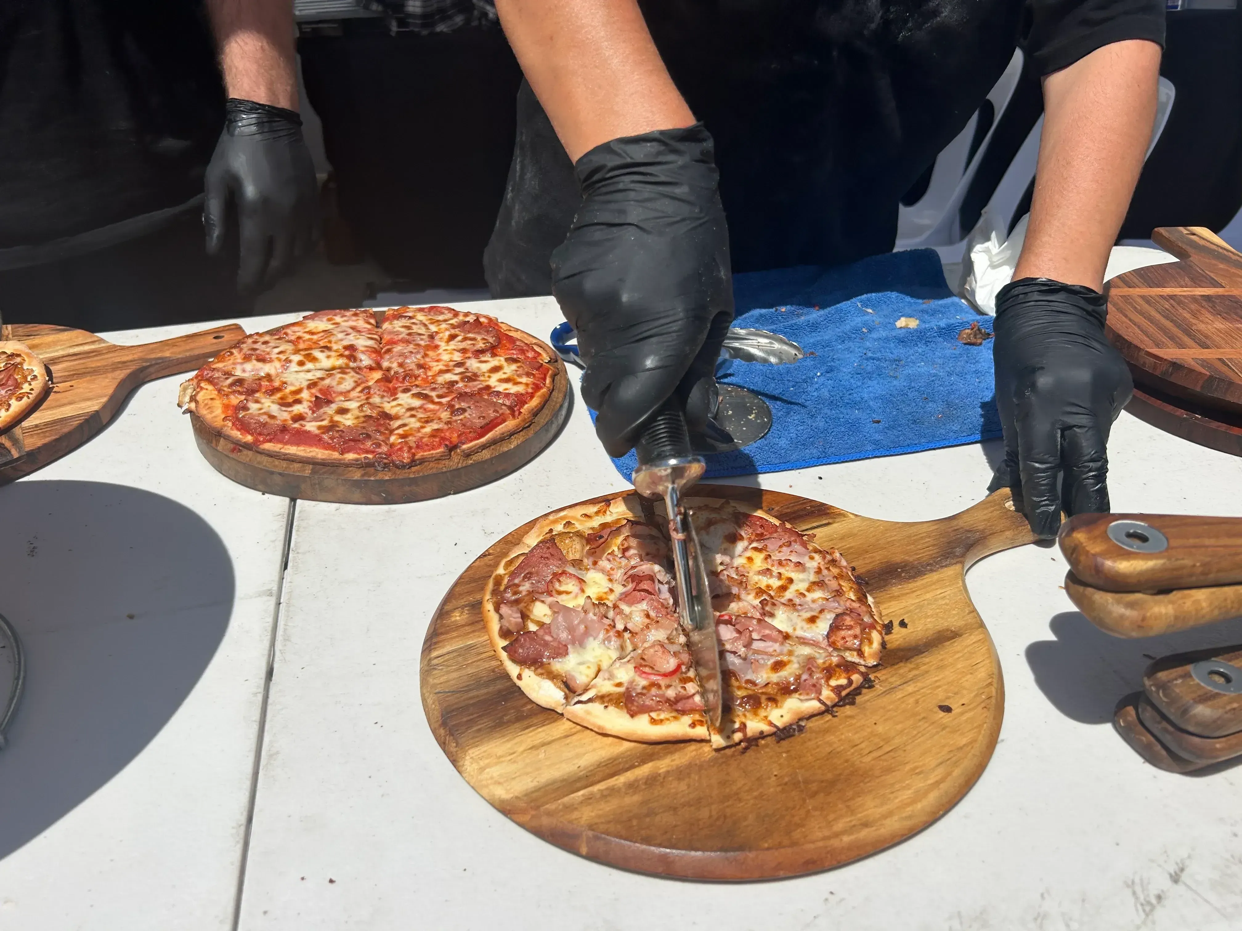Fresh pizzas being sliced for guests at Bravofoods Prestons factory launch catering
