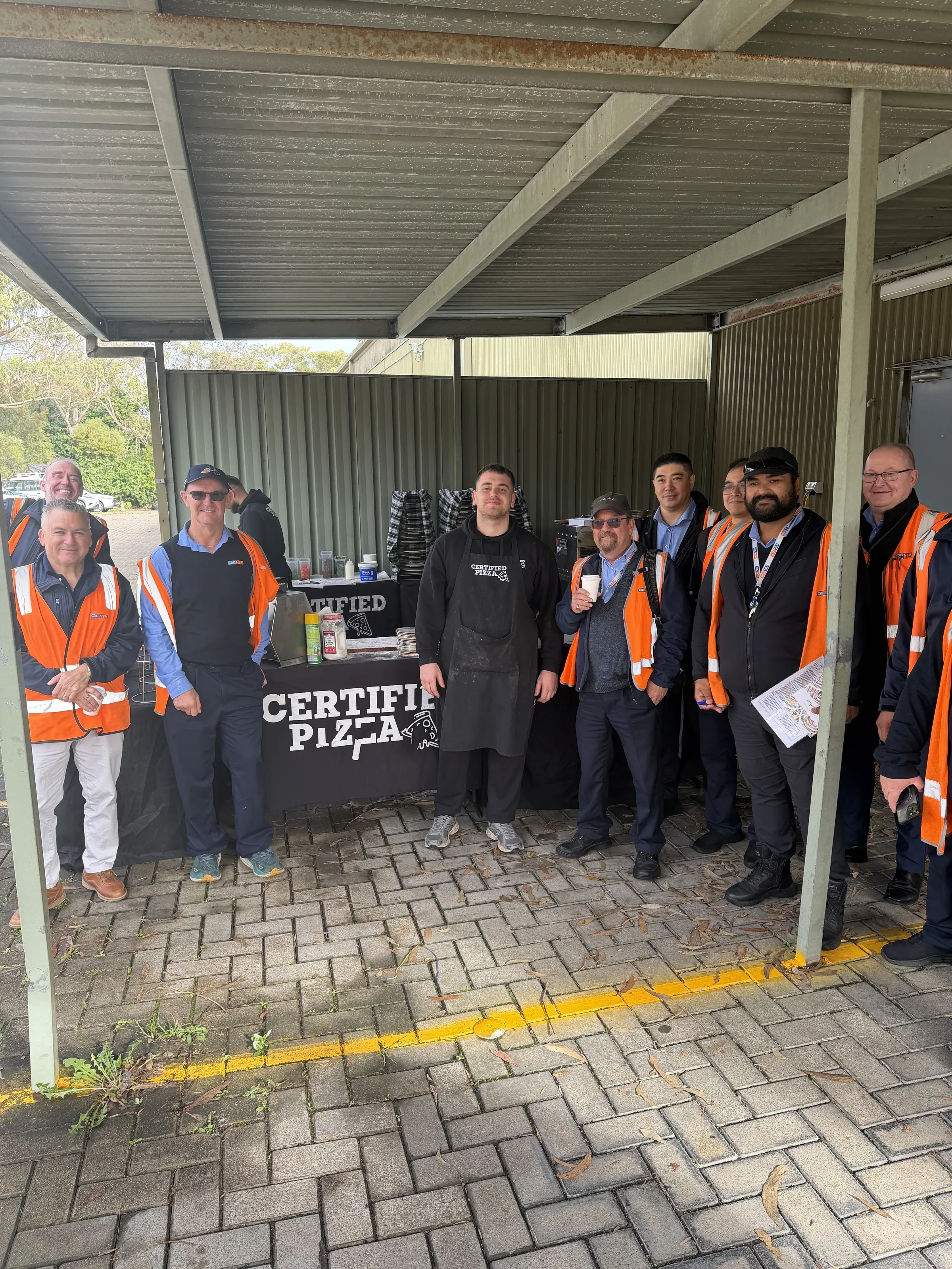 CDC NSW staff in high-vis with Certified Pizza catering at Seven Hills