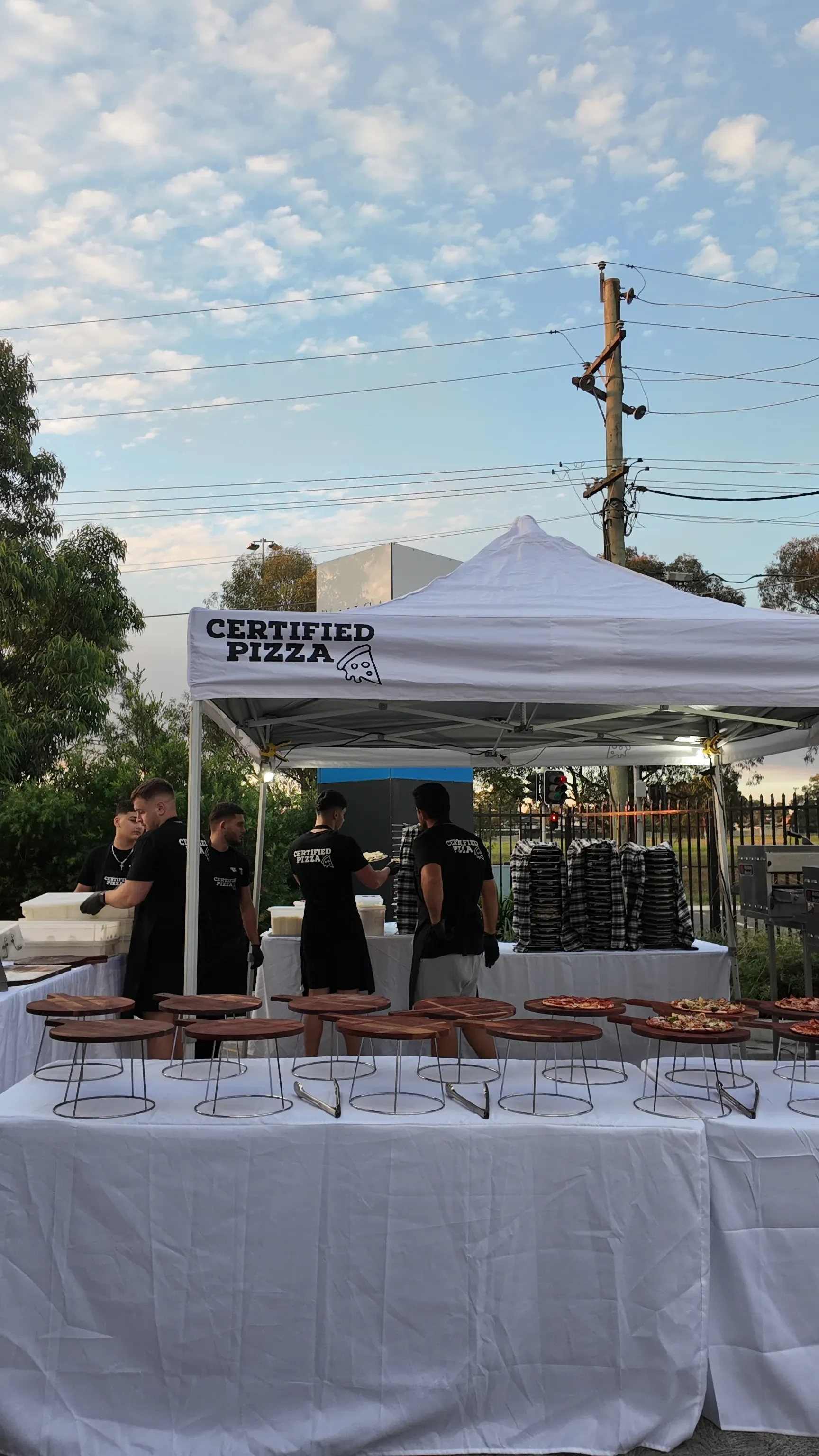 Branded marquee and conveyor oven setup at a Sydney night event